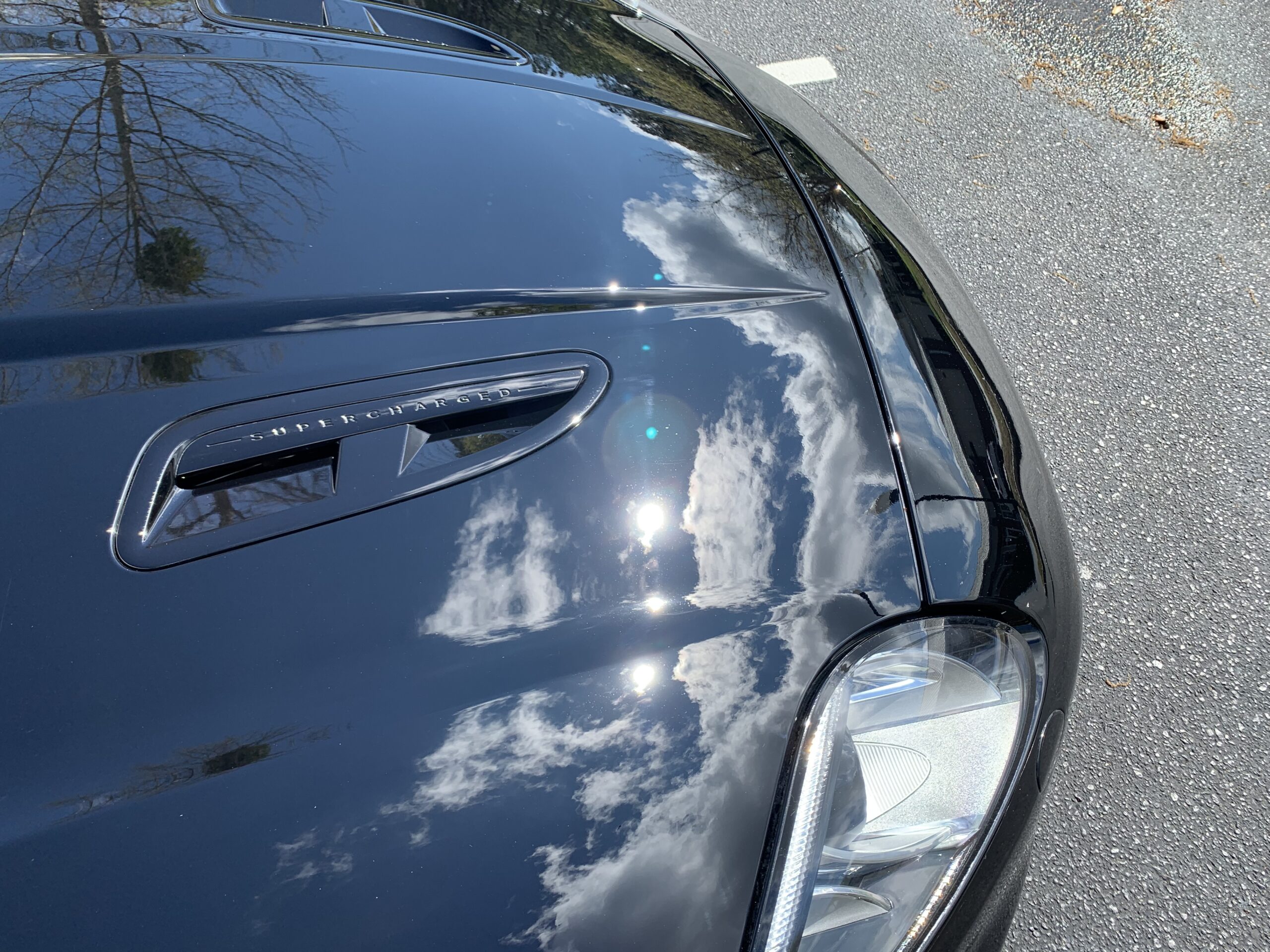 Sun Reflecting on Black Jaguar Hood